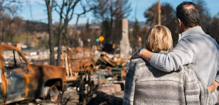 Parrish Group: Couple surveys damage after bushfire destroys home